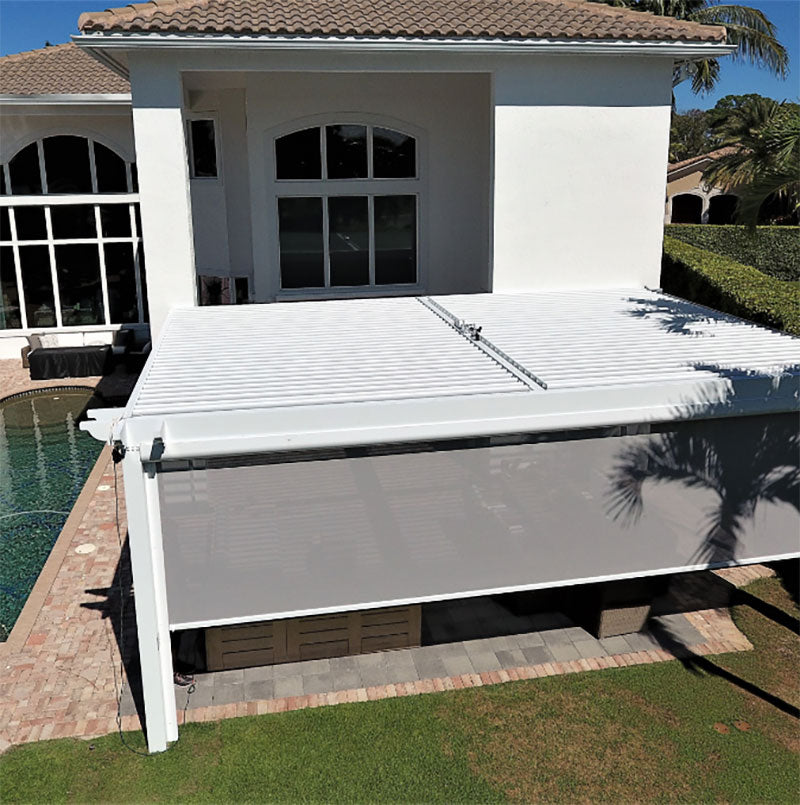 A white louvered pergola beside a swimming pool with a motorized screen lowered along one side.